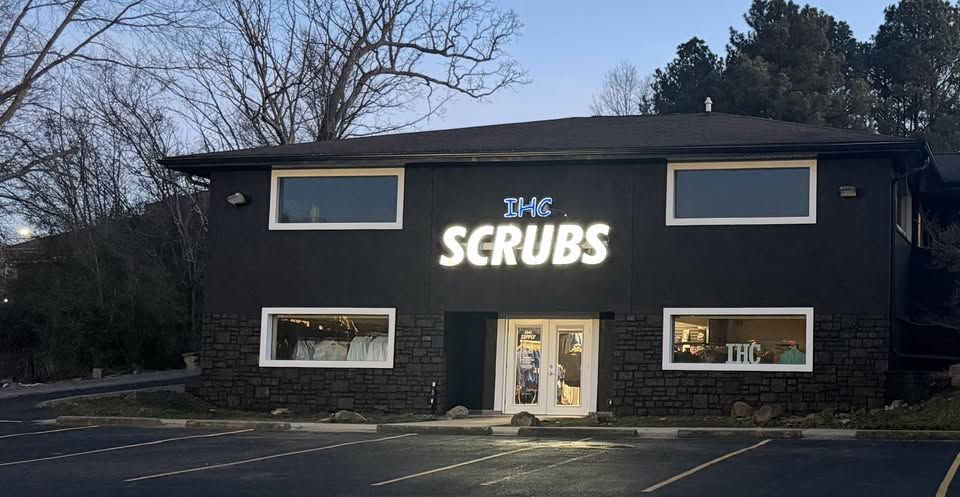 The IHC Scrubs storefront on Section Line Road at dusk